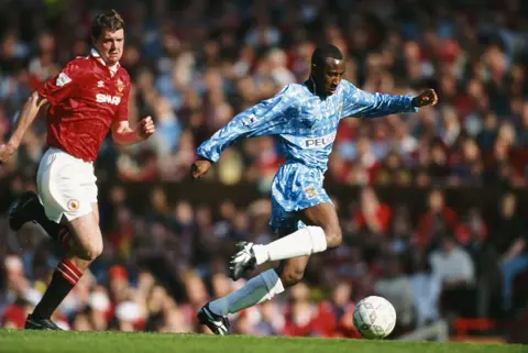 Getty Images Coventry City striker Peter Ndlovu outpaces Manchester United defender Gary Pallister during a FA Premier League match between Manchester United and Coventry City at Old Trafford on May 8, 1994