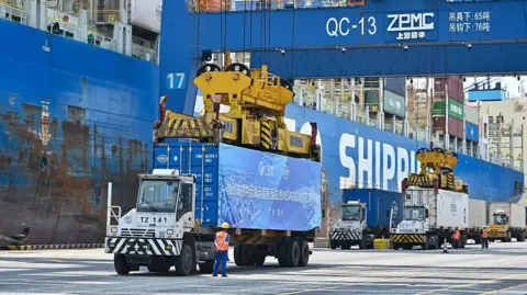 Trucks transfer containers at Nansha Port on April 29, 2025 in Guangzhou, Guangdong Province of China. G