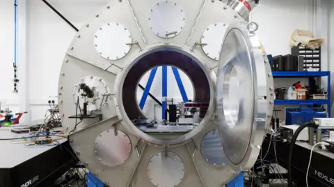 A large metal cylinder in the middle of a laboratory.