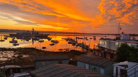 THURSDAY - A vivid orange sunrise over Gosport harbour with boats at low tide