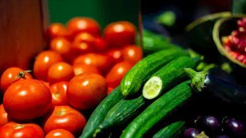  A display of tomatoes, cucumbers and aubergines 