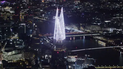 An aerial image of The Shard with white Christmas lights shining