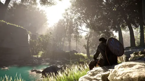 Pearl Abyss Screenshot from Crimson Desert shows the player character sitting in a forest clearing taking a breather next to a pond. Late afternoon sunlight streams through the trees, illuminating the scene in a convincingly lifelike manner.