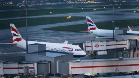 British Airways planes sitting at gates at Heathrow Airport