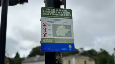 PSPO sign in Tavistock. The sign says: 'You are in an area controlled by a public space protection order'.