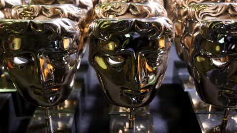 EPA-EFE/REX/Shutterstock A collection of Bafta Award trophies on display