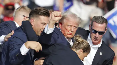 EPA Former US President Donald Trump is rushed off stage by secret service after an incident during a campaign rally at the Butler Farm Show Inc. in Butler, Pennsylvania, USA, 13 July 2024. 