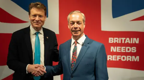 PA Media eader of Reform UK Richard Tice and Nigel Farage during a press conference to announce their party's legal immigration policy, at The Glaziers Hall in London, while on the General Election campaign trail. 