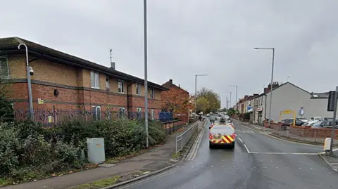 Deepdale Road, Preston, showing vehicles in a line of traffic and a car park on the right