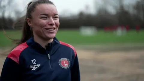 Jodie Hutton talking to the camera on the pitch