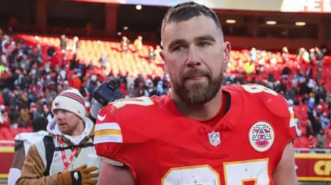Travis Kelce looks disappointed as he leaves the field following the Kansas City Chiefs' defeat to the Los Angeles Chargers