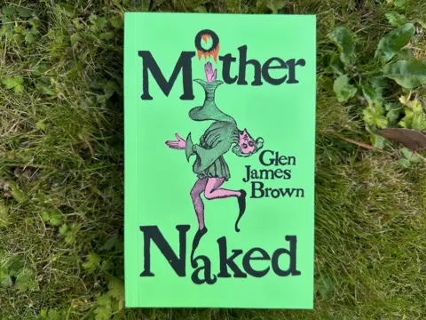 A book with a green cover and a medieval type character dancing between the words Mother and Naked, with the author's name to the right