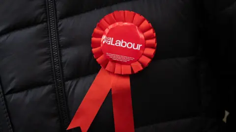 Getty Images A Labour Party rosette shown on an unidentified man wearing a black coat