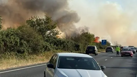 Cars being abandoned on the A31 as a fire breaks out in Heathland