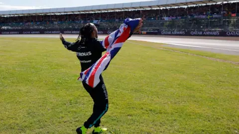 Reuters Lewis Hamilton celebrating with the British flag