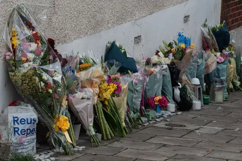 Getty Images Floral tributes are left at Kirkstall Gardens following the shooting death of Chris Kaba, also known as rapper Madix, on September 8, 2022 in London, England. Chris Kaba, 24, was shot dead by a Met police officer after a car chase ended in Streatham Hill on Monday night. No firearms were found at the scene. (Photo by Guy Smallman/Getty Images)