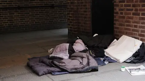Getty Images A stock image of a sleeping bag outdoors against a brick wall.