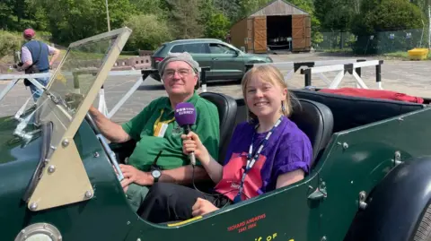 A man and a woman sitting in a car