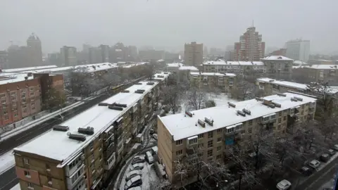 Leila Osman Snow covers several blocks of flats along with cars