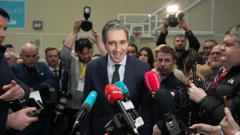 PA Media Taoiseach and Fine Gael leader Simon Harris speaks to the media as he arrives at the election count centre at Shoreline Leisure Greystones