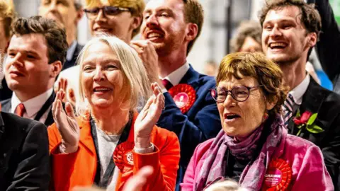 Labour party members celebrate as the counting of votes continues, during the UK election in Edinburgh