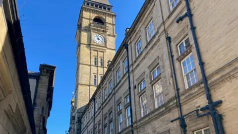 Wakefield Town Hall - a large, sandy coloured brick building with a tall clocktower.