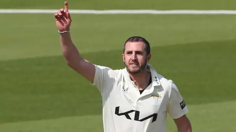 Dan Worrall, index finger raised, celebrates a wicket