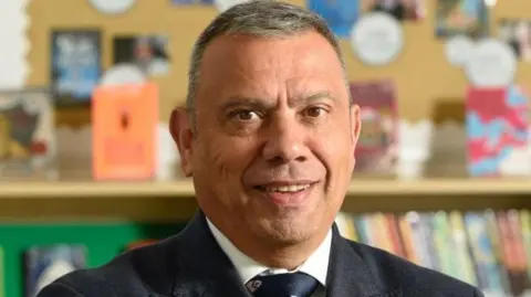 Northampton International Academy Martin Serrao - man with very short dark hair wearing a suit and tie