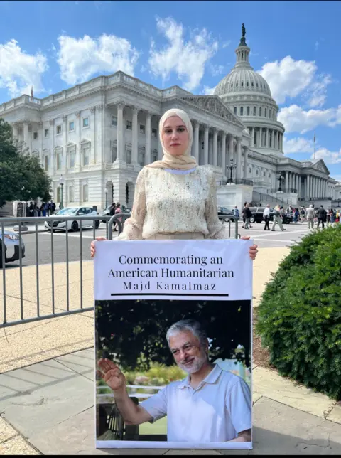 Maryam Kamalmaz Maryam Kamalmaz with a photograph  of her begetter  