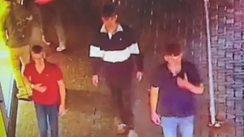 West Mercia Police A group of men walking along a street