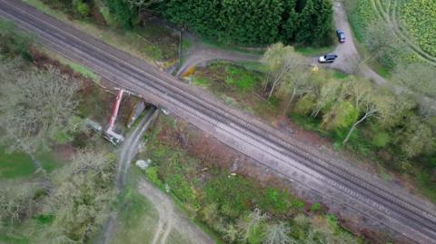 An aerial view of the embankment being supported by machinery