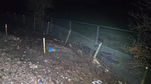 Network Rail Evidence of the landslip at night next to the track.