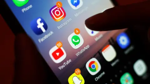 A phone showing social media icons