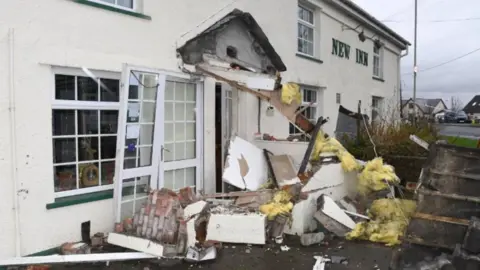 Crown Prosecution Service A photo of a damaged pub with lots of debris outside the front