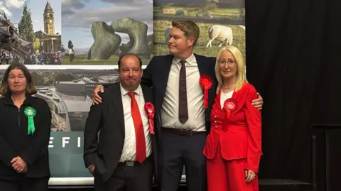 A group of Labour members look glum as results are read. 