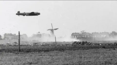 IBCC Archive photo of a Lancaster Bomber flying low over The Netherlands.