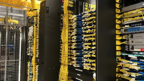 A massive set of organised cables and wires. Much of the wiring is yellow.