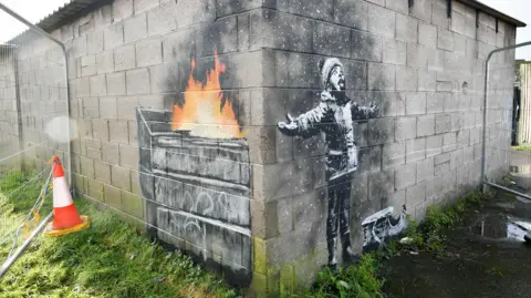 PA Banksy artwork on a garage in Port Talbot.