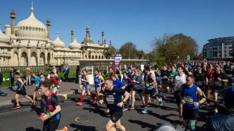 Govia Thameslink Railway Runners passing the Brighton Pavilion.