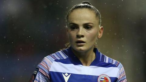 Lily Woodham pictured while playing for Reading, wearing a blue and white Reading home shirt 