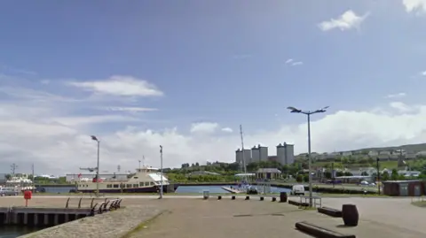 Google A harbour bay, with a yacht sitting by the dock