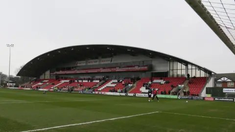 Rex Features A general view of a stand at Fleetwood's stadium. It has an arched roof and is single-tier with red seats. The pitch is in front of it.