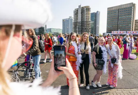 EPA Harry Styles fans pose for a photo outside the Cruijff Arena in Amsterdam