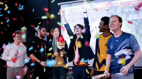 Cameron Dray Six boys from the Roehampton esports team celebrating a win at a competition.