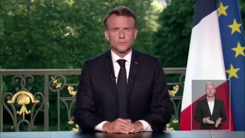 French President Emmanuel Macron giving code  