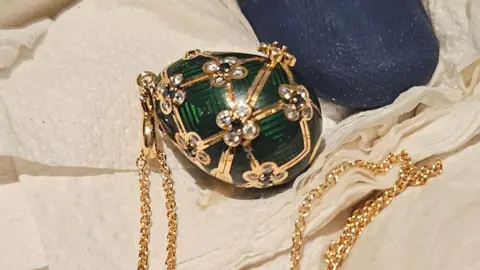 New Zealand Police An emerald green Octopussy Fabergé egg locket placed on serviettes
