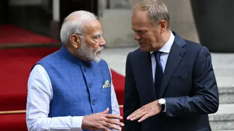 Getty Images Polish Prime Minister Donald Tusk (R) welcomes Indian Prime Minister Narendra Modi to a meeting in front of the Polish Prime Minister's Office in Warsaw, Poland, on August 22, 2024. 