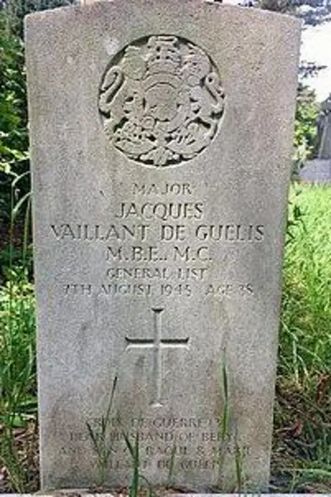 Friends of Cathays Cemetery A roughly 3ft high headstone bearing his name and military achievements. At its top is a carved representation of the Royal Coat of Arms emblem, showing a lion and unicorn 