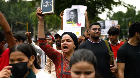 Activists and supporters of the Cockroach Janta Party (CJP) take part in a protest demanding the resignation of India's Education Minister Dharmendra Pradhan over alleged NEET examination irregularities in New Delhi on July 20, 2026