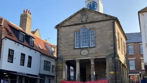 Whitby's Old Town Hall and surrounding buildings set in the market square